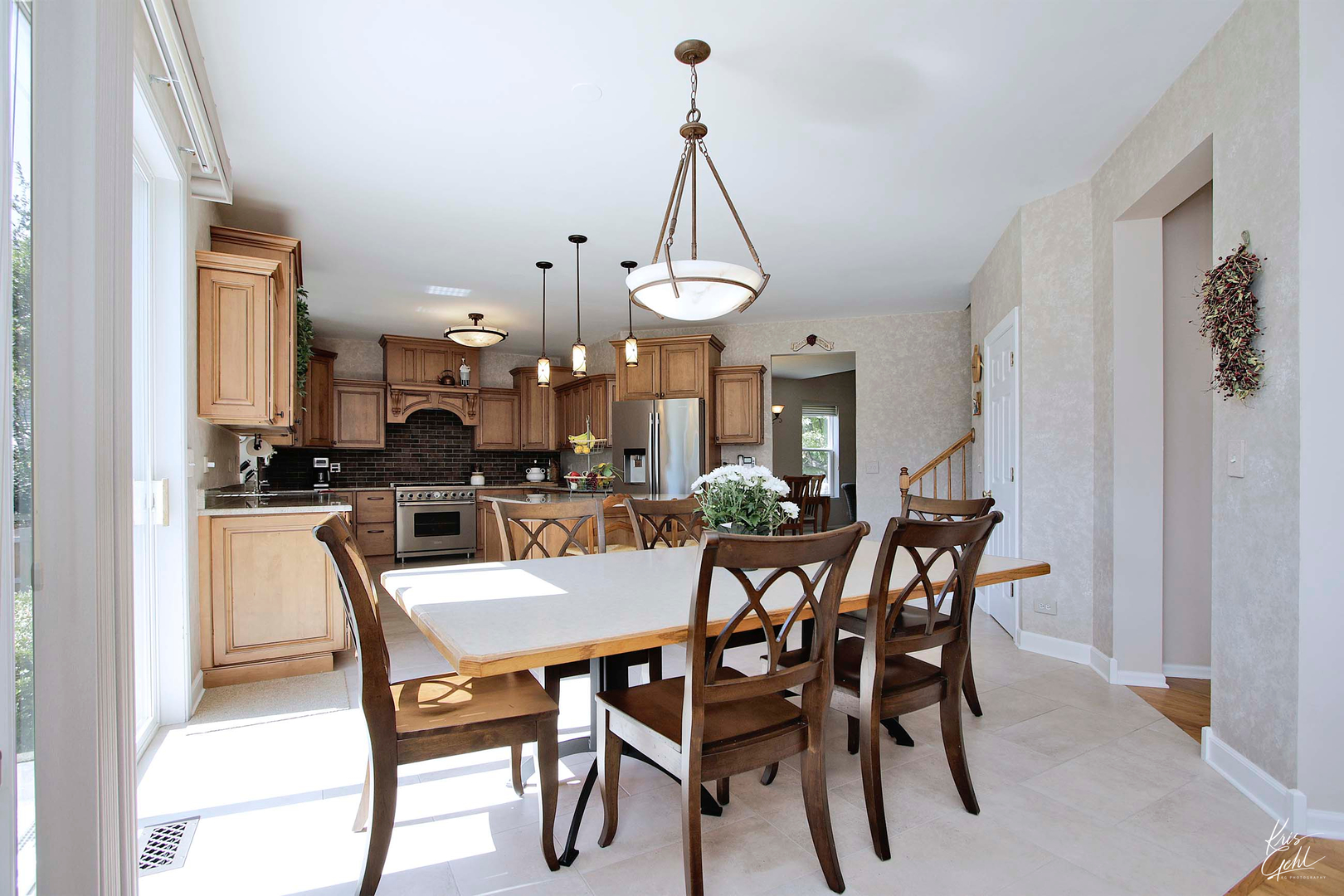 515 Capital Lane Gurnee, IL 60031 - Photo 12 of 32 a view of a dining room and livingroom with furniture wooden floor a chandelier