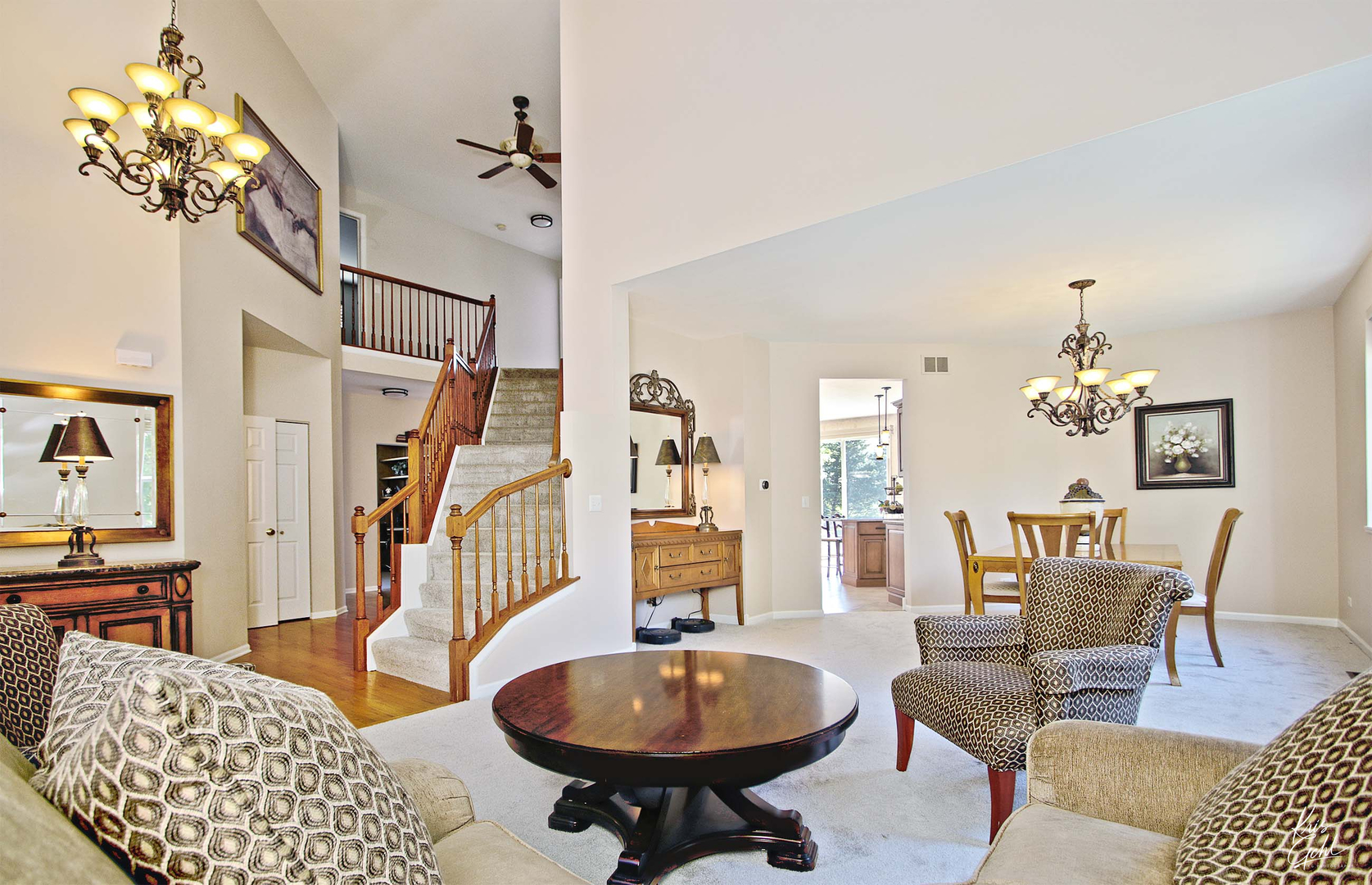 515 Capital Lane Gurnee, IL 60031 - Photo 3 of 32 a dining room with wooden floor a chandelier a glass table and chairs