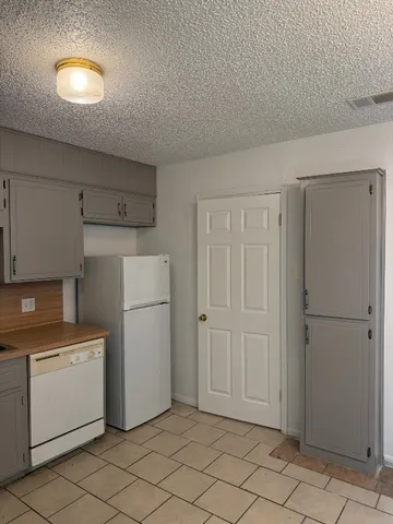 a utility room with cabinets washer and dryer