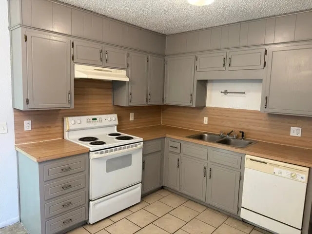 a kitchen with cabinets appliances and a sink