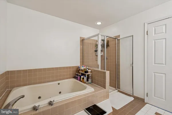 a bathroom with a tub and a shower