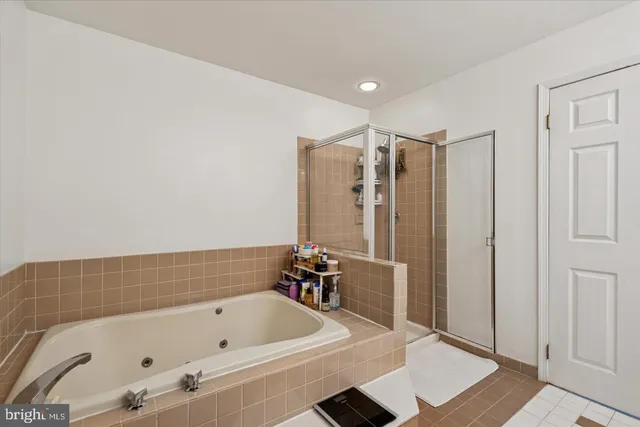 a bathroom with a tub and a shower