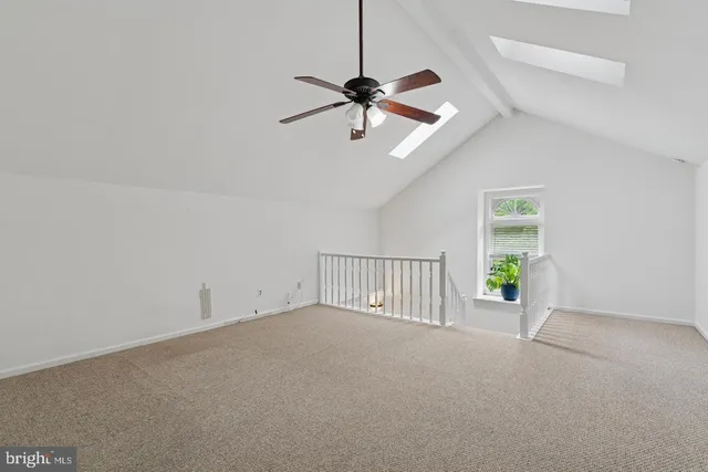 a view of a livingroom with a ceiling fan and window