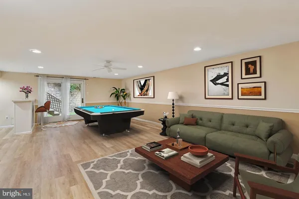 a living room with furniture a rug and a table