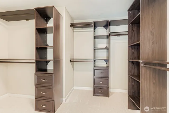 a view of walk in closet with empty racks