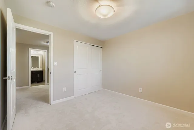 an empty room with windows and entrance