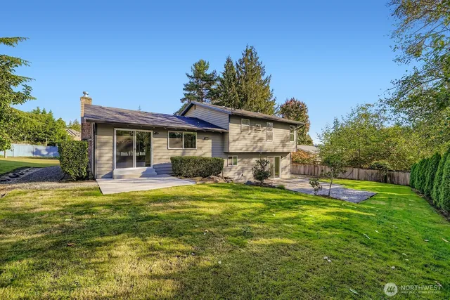 a view of a house with a yard patio and fire pit