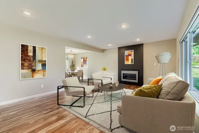 a living room with fireplace furniture and a wooden floor