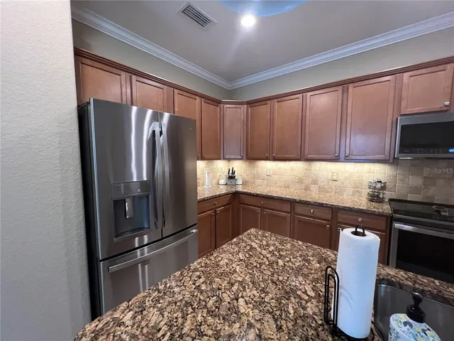 a kitchen with a sink and a stove top oven
