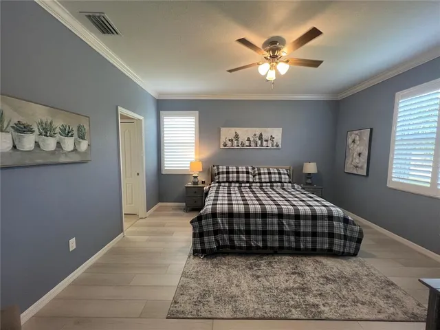 a bedroom with a bed and a chandelier