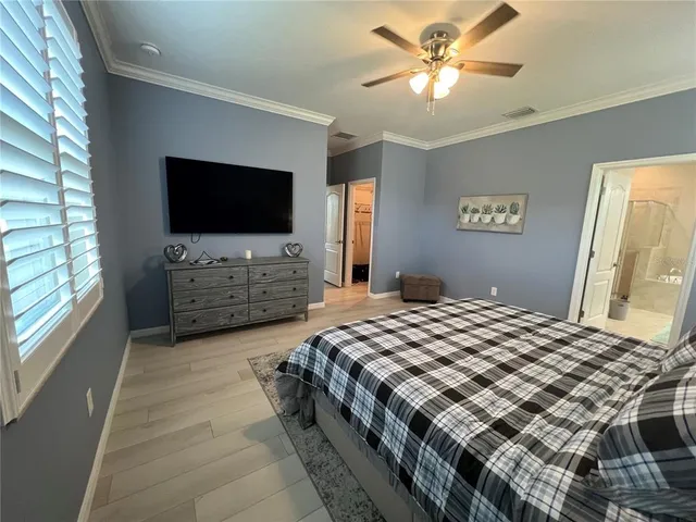 a bedroom with a large bed and a tv