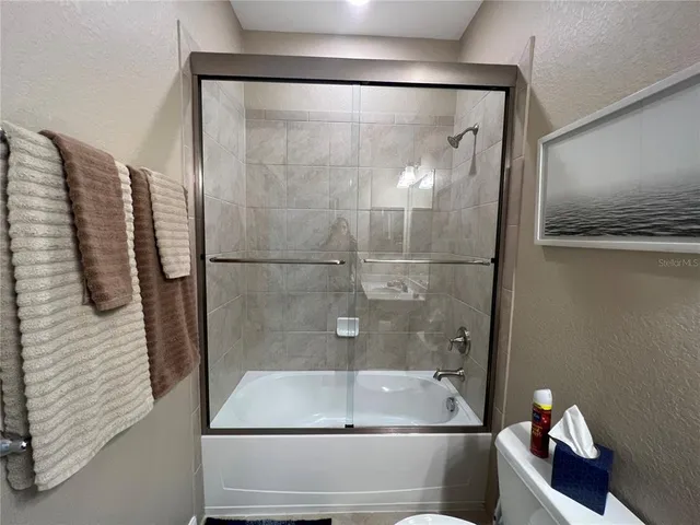 a bathroom with a sink vanity mirror and toilet