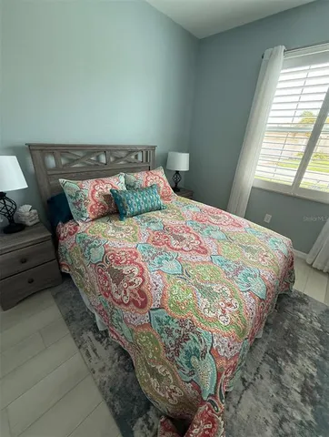 a bedroom with a bed and window