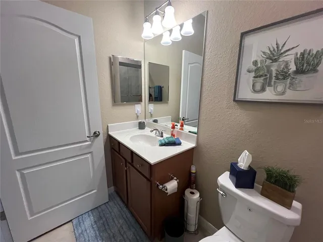 a room with pool table and windows