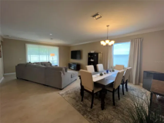 a view of a dining room with furniture and window