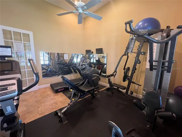 a kitchen with granite countertop a refrigerator and a stove top oven