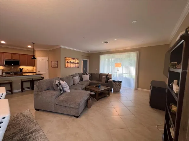 a living room with furniture and a chandelier