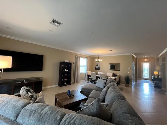 a kitchen with refrigerator a sink and chairs