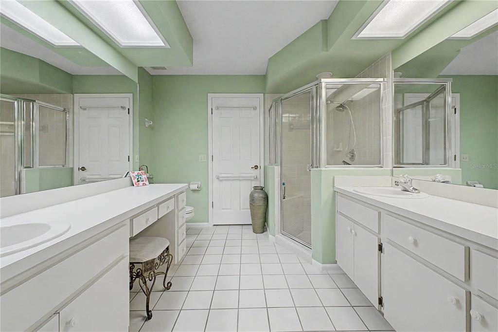 2662 Appleleaf Court Spring Hill, FL 34606 - Photo 18 of 47 a spacious bathroom with a double vanity sink a mirror and a bathtub