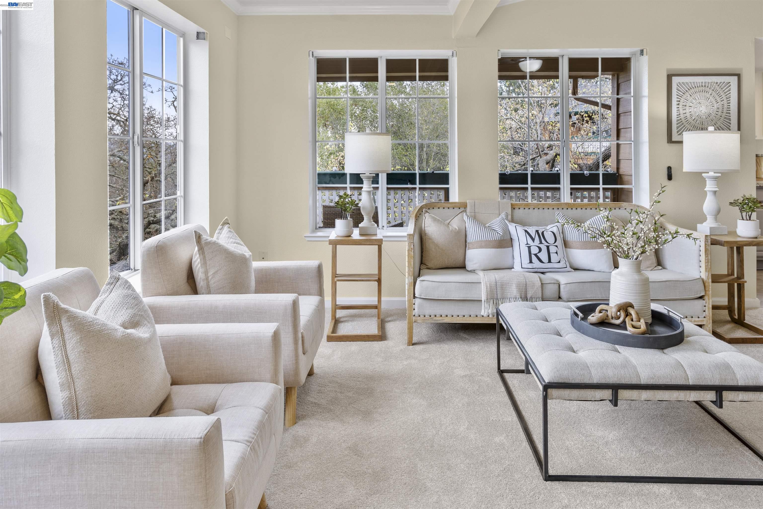 a living room with furniture and a floor to ceiling window