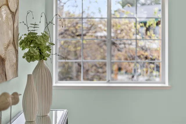 a vase of flowers sitting next to a window
