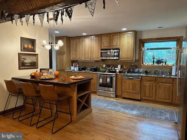 a kitchen with a sink cabinets and wooden floor