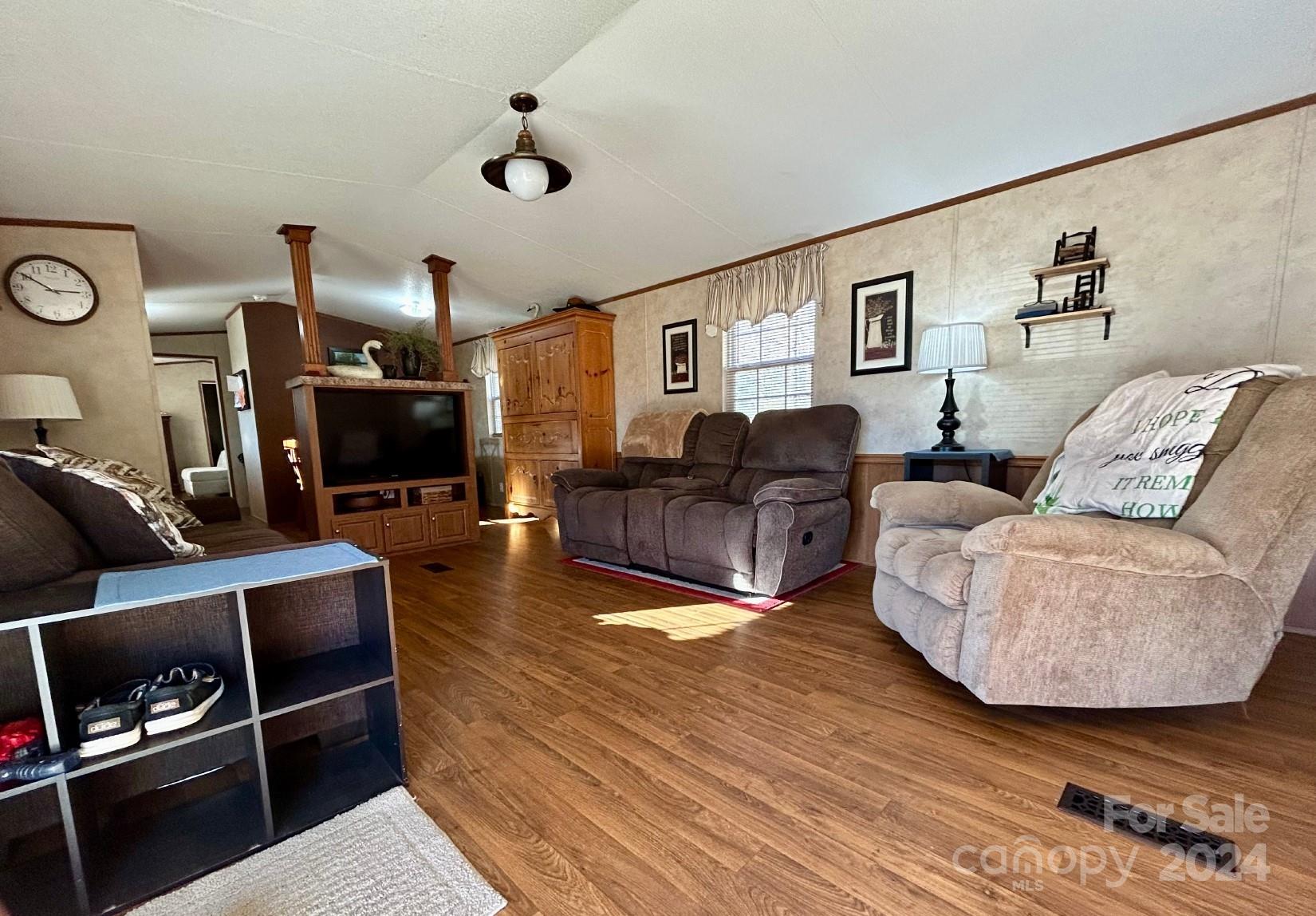 7486 Buff Allen Road Hickory, NC 28602 - Photo 3 of 13 a living room with furniture a flat screen tv and a fireplace