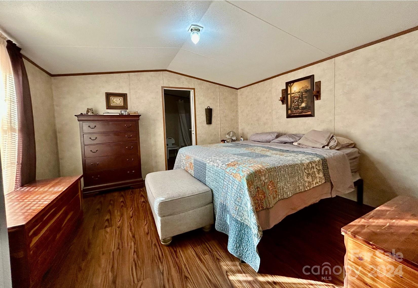 7486 Buff Allen Road Hickory, NC 28602 - Photo 5 of 13 a bedroom with a bed and a dresser