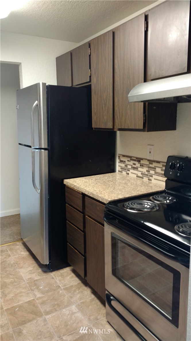 817 North 4th Street Renton, WA 98057 - Photo 5 of 7 a kitchen with stainless steel appliances granite countertop a refrigerator and a stove