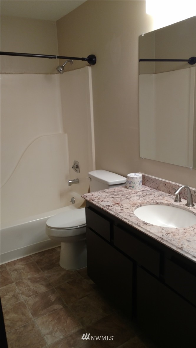 817 North 4th Street Renton, WA 98057 - Photo 6 of 7 a bathroom with a granite countertop sink toilet and shower