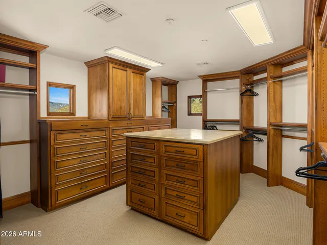 a bedroom with furniture and a large window