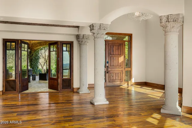 a large kitchen with stainless steel appliances granite countertop a lot of counter space and wooden floors