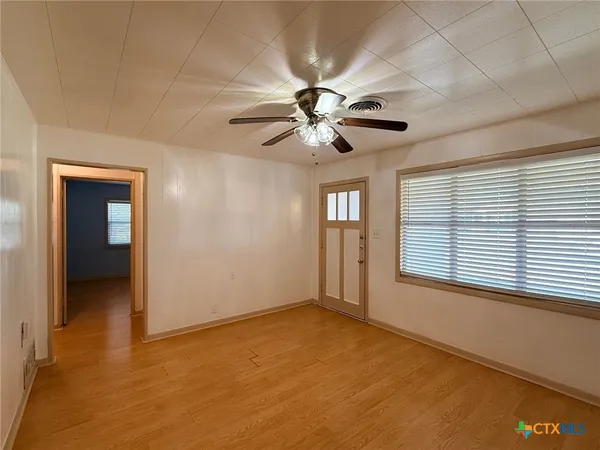 a view of an empty room with a window
