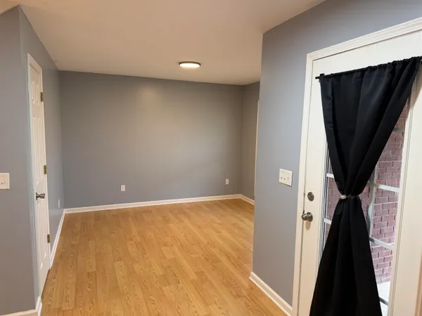 a view of a room with a wooden door