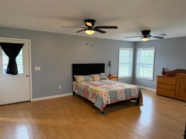 a bedroom with a bed and a chandelier
