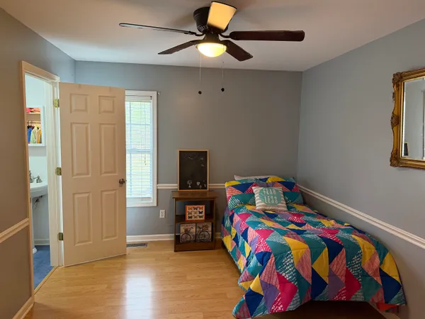 a bedroom with a bed and a tv