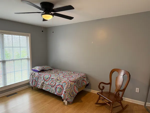 a bedroom with a bed and a window