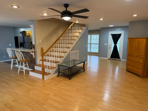 a living room with furniture and a wooden floor