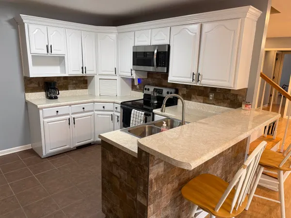 a kitchen with a sink cabinets and wooden floor