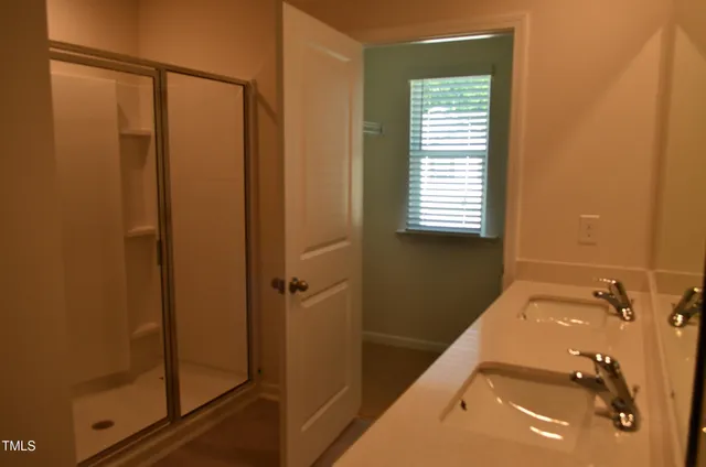 a bathroom with a shower and a sink