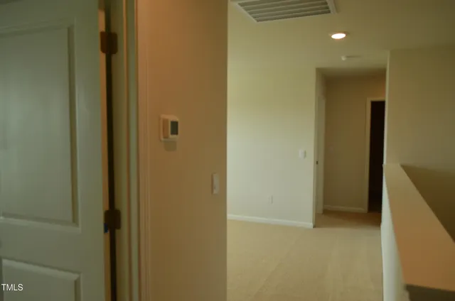 a view of a hallway with front door