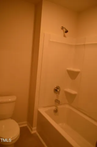 a bathroom with a toilet and a tub