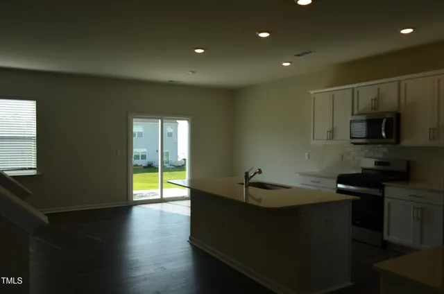 a kitchen with sink and cabinets