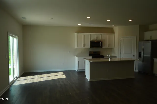 a living room with hard wood floors and a wooden floor