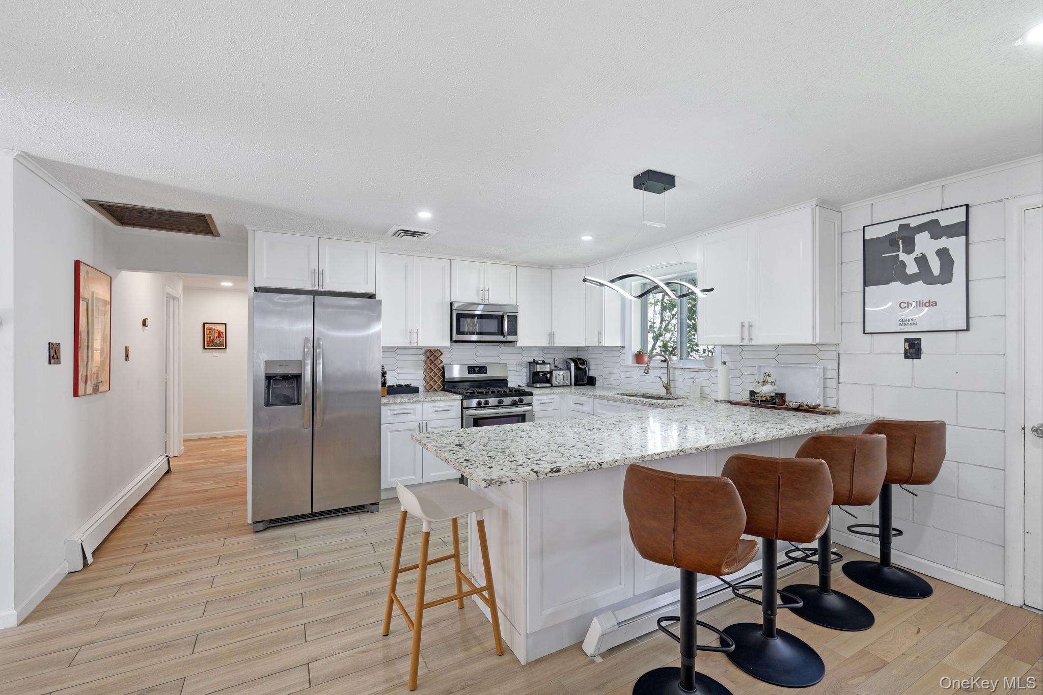 35 Kroeger Road Monticello, NY 12701 - Photo 6 of 29 a kitchen with stainless steel appliances kitchen island granite countertop a refrigerator and a stove top oven