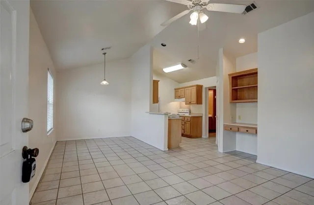 a view of a kitchen with a sink and a refrigerator