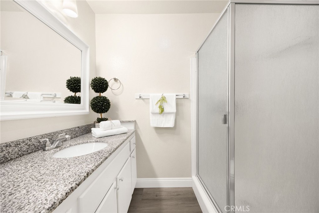 3020 Associated Road, Unit 110 Fullerton, CA 92835 - Photo 11 of 34 a bathroom with a granite countertop sink and a mirror