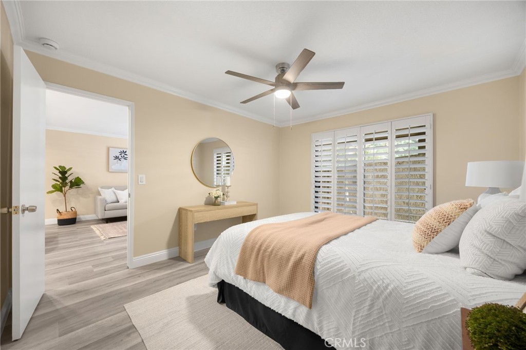 3020 Associated Road, Unit 110 Fullerton, CA 92835 - Photo 16 of 34 a bedroom with a large bed and a chandelier