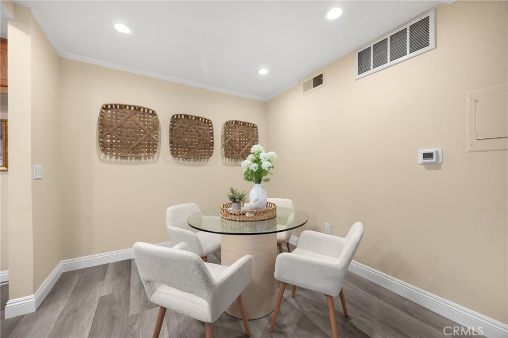 3020 Associated Road, Unit 110 Fullerton, CA 92835 - Photo 17 of 34 a dining room with furniture and wooden floor