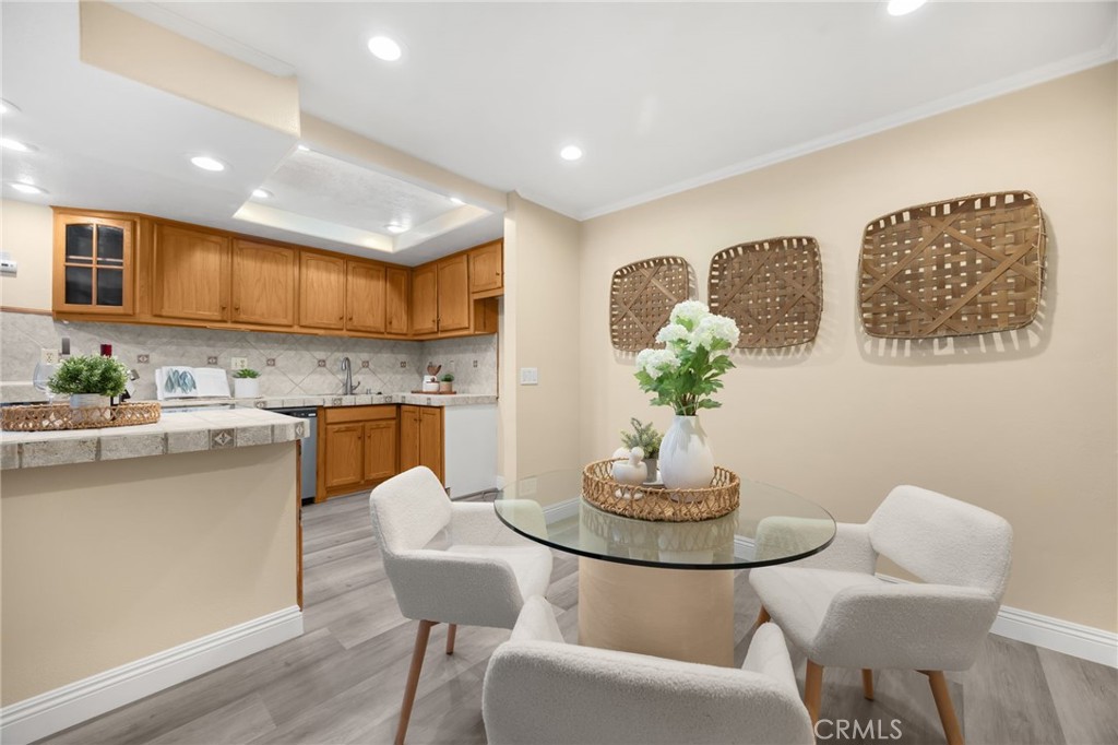 3020 Associated Road, Unit 110 Fullerton, CA 92835 - Photo 18 of 34 a kitchen with stainless steel appliances granite countertop a dining table and chairs